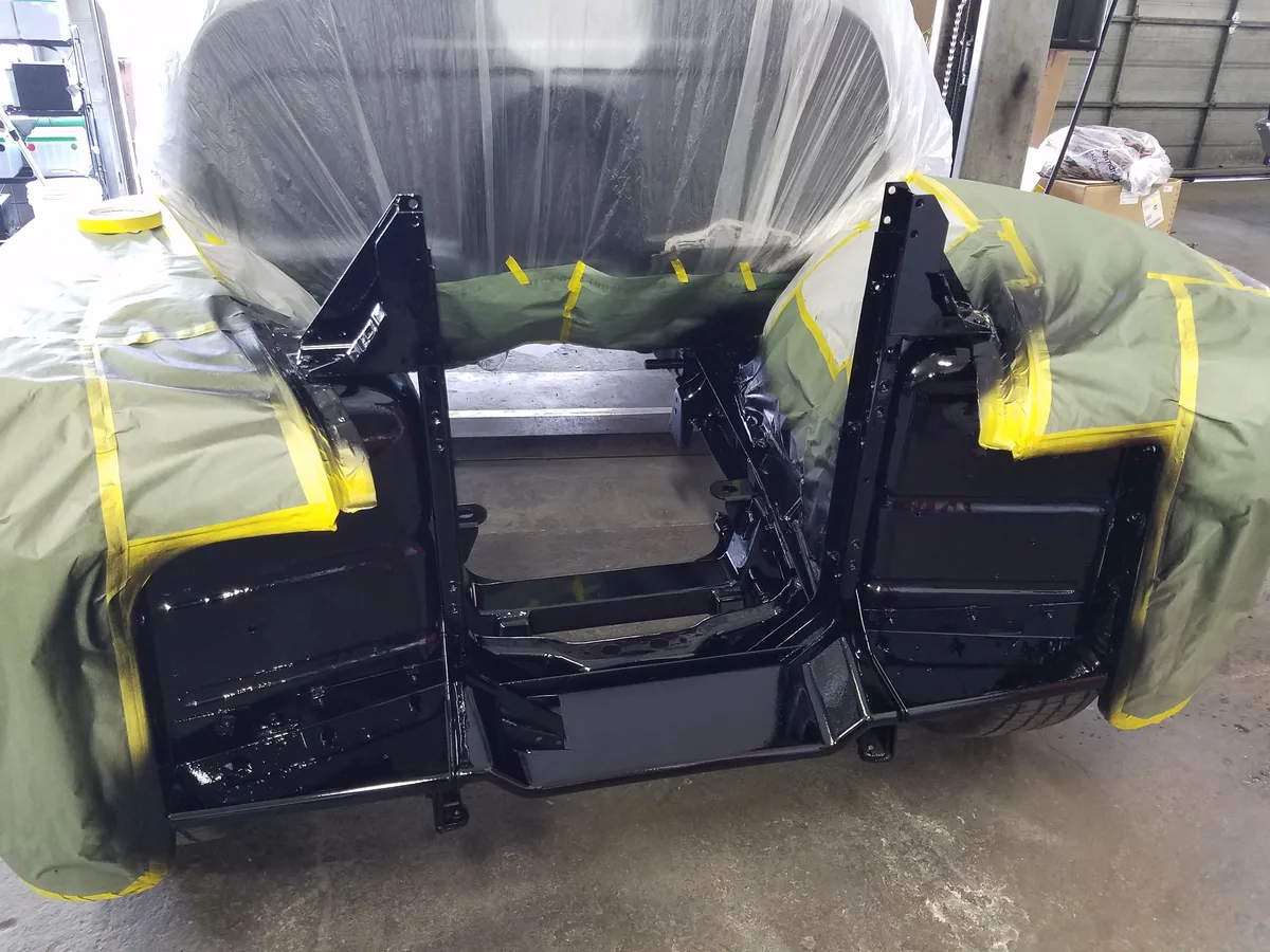 Car panels masked and prepped for paint in Ruben's spray booth