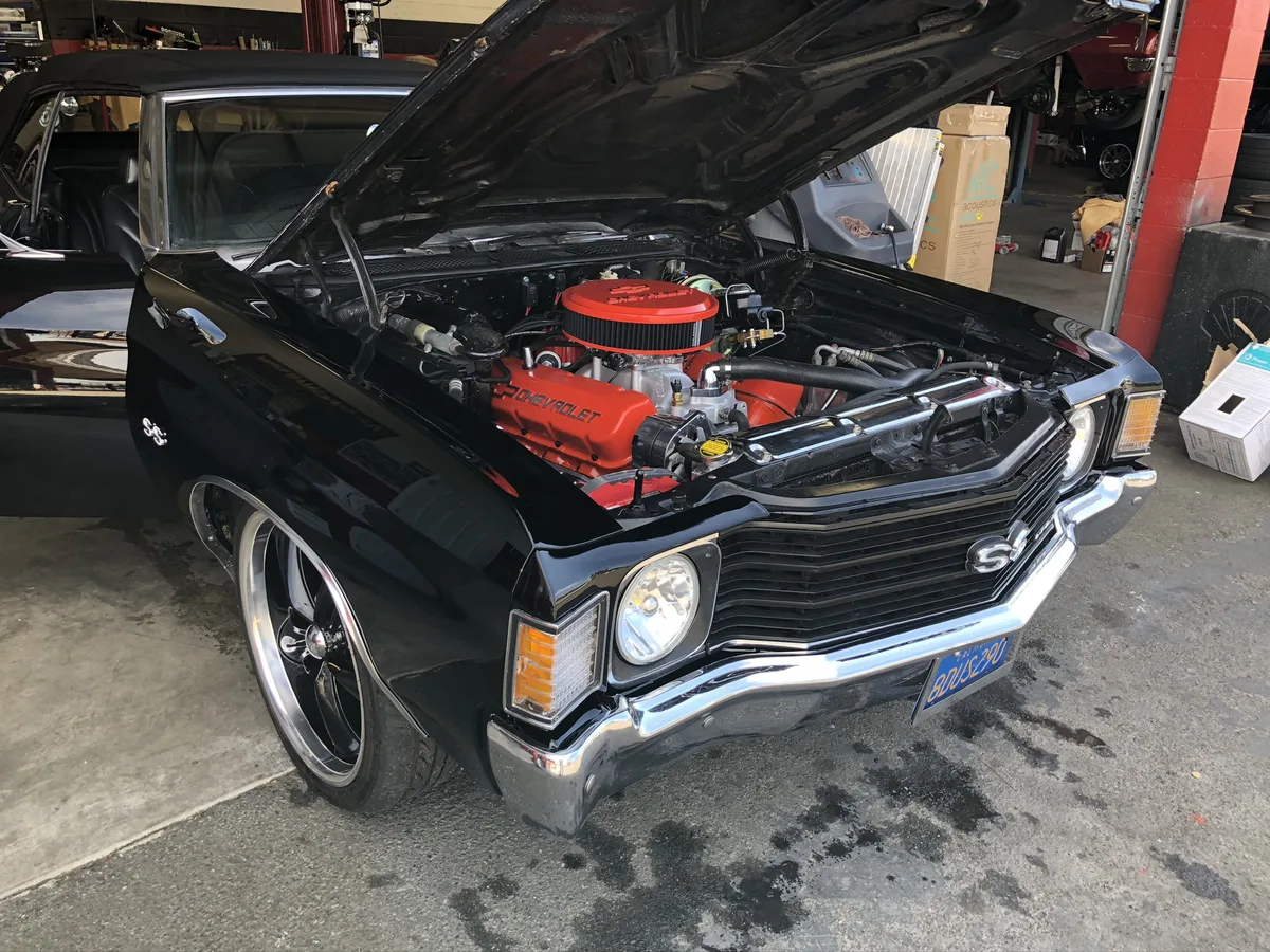 Black Chevrolet SS with red engine at car show