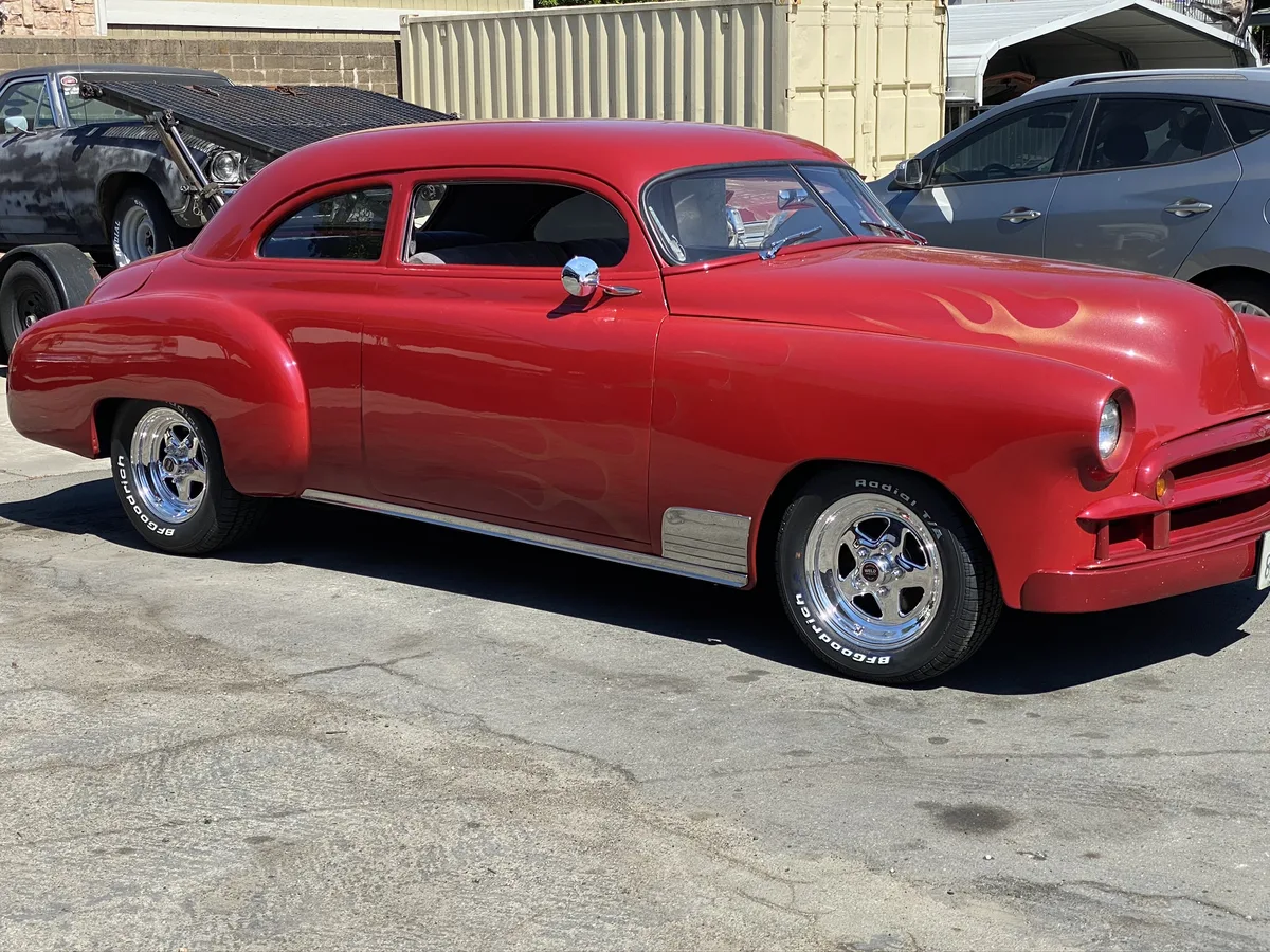 Red classic coupe at Ruben's shop exterior